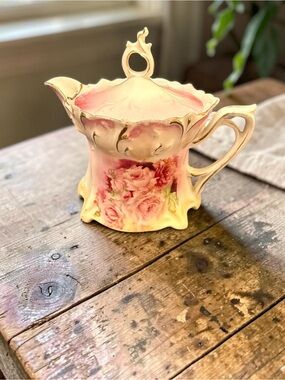 A vintage R. S. Prussia Russian porcelain creamer with pink roses and gold trim.